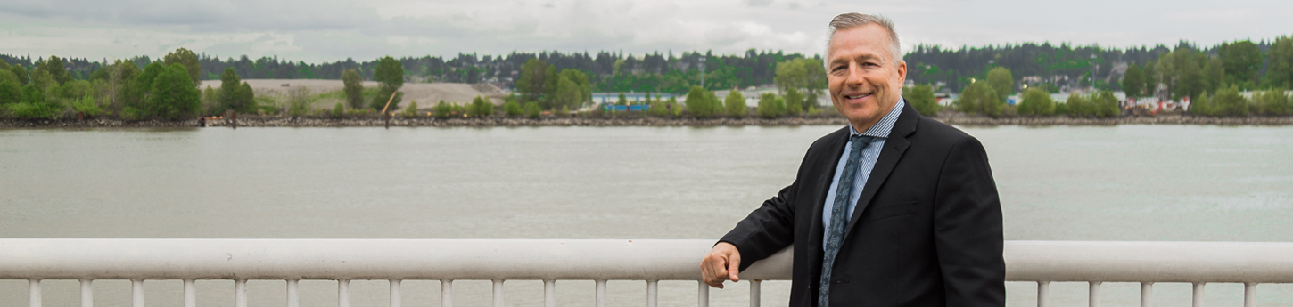Andrew Hopkins in front of the Fraser River in New Westminster